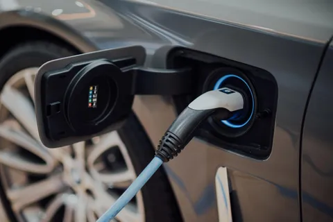 Close-up of EV charger plugged into electric vehicle’s charging port.