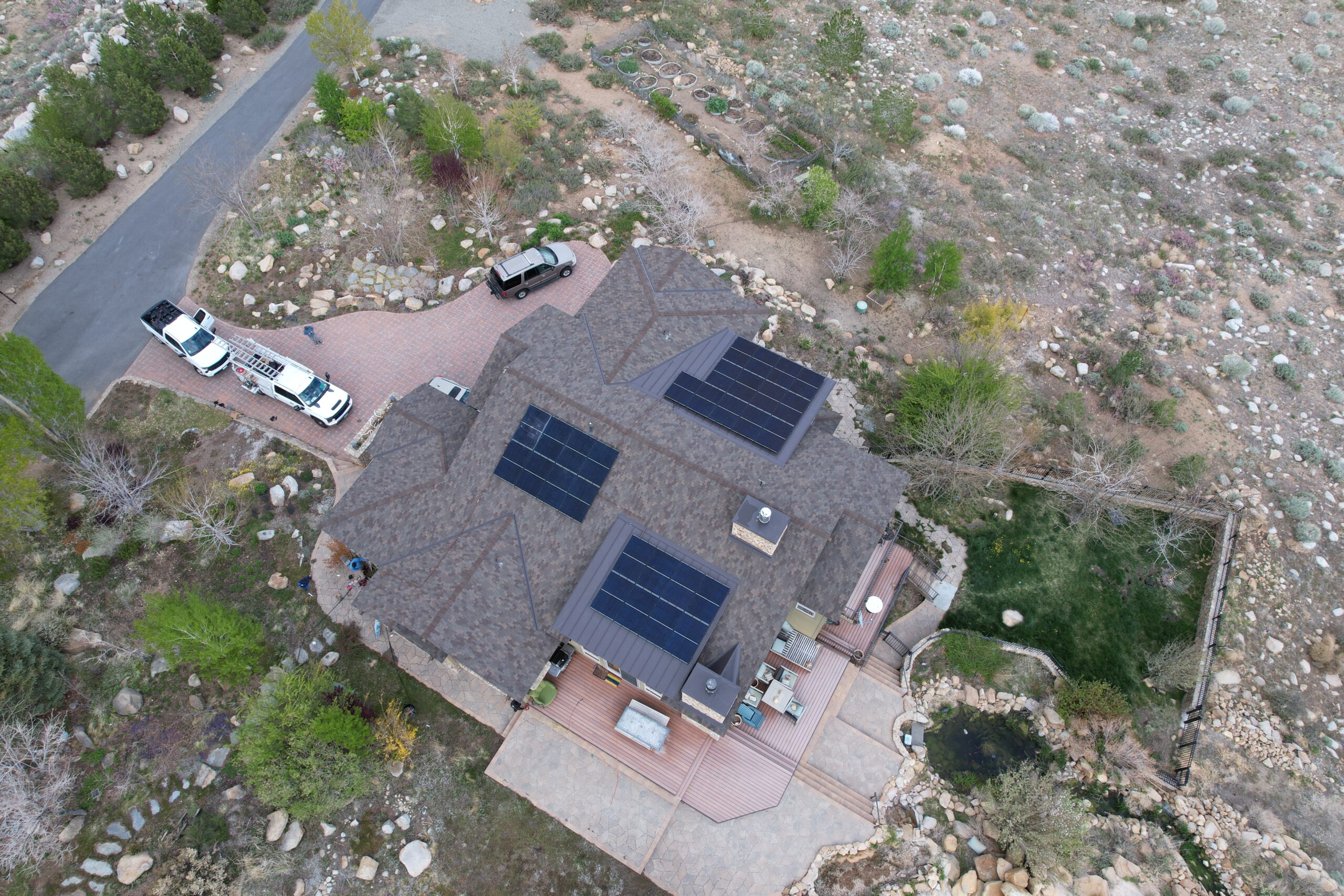 Aerial view of countryside home with rooftop solar energy system.